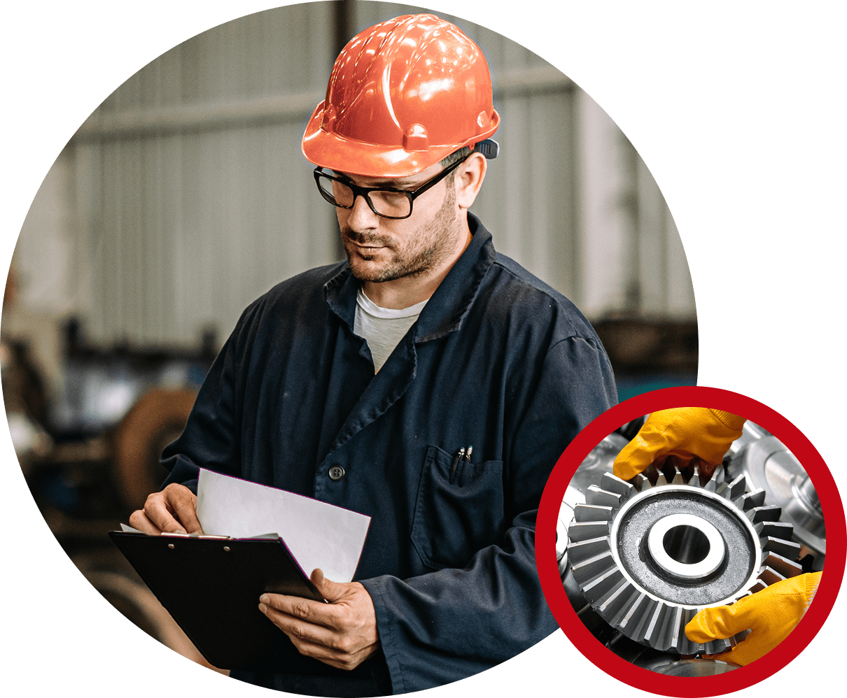 Worker in helmet inspecting machine part.